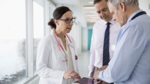 A group of healthcare workers talking in a hospital.