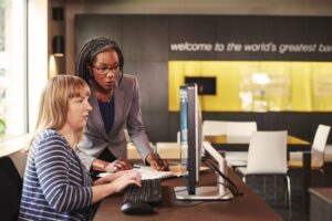 Financial analyst assisting a bank teller with an account