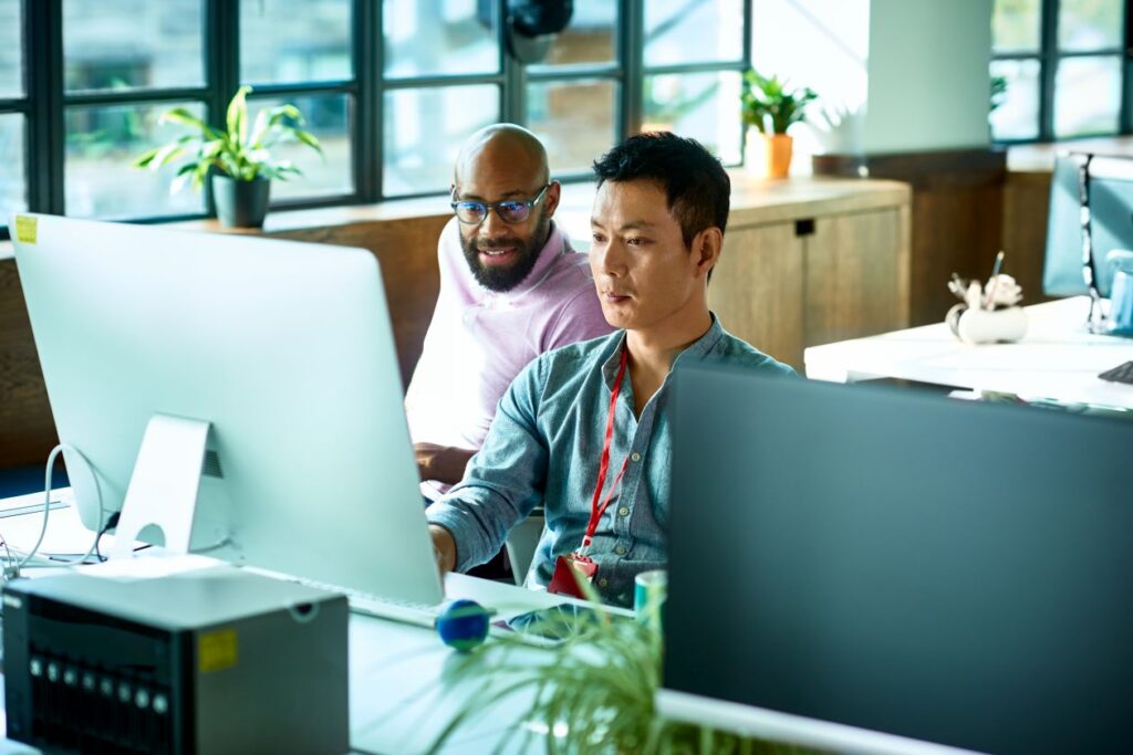 A group of men looking at a computer screen