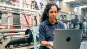 A woman sitting at a table using a laptop