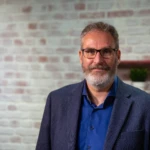 A man wearing glasses posing for the camera