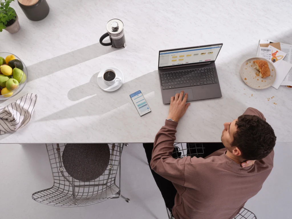 Man using MFA on his phone to access apps, as part of a security policy.
