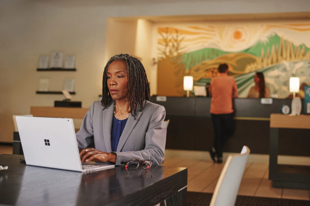 Financial analyst working on a Surface Book in a bank.