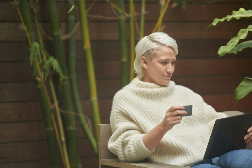 Woman online shopping at home. Connected commerce builds better brand trust.