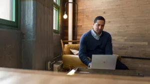 Small business male achieving with a Surface in modern workplace.