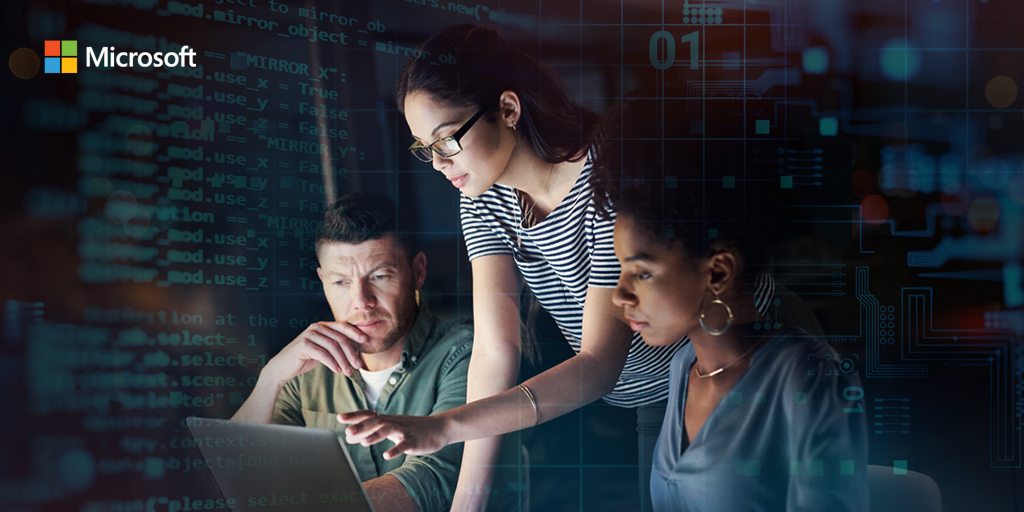 two woman and a man looking at a laptop screen together