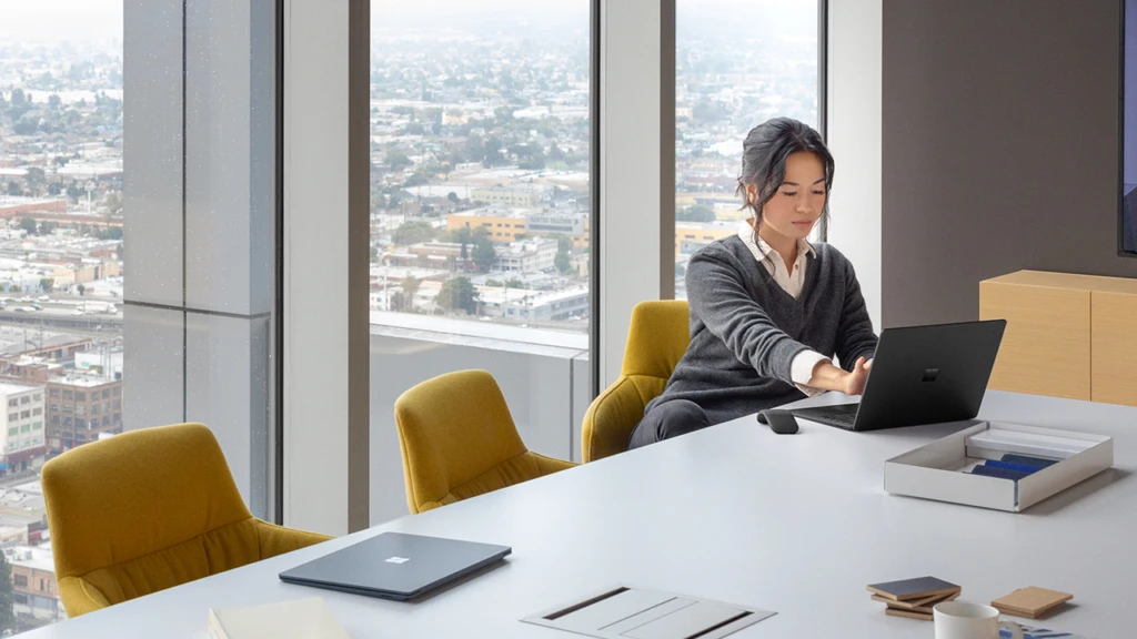 Woman working on her laptop in a conference room