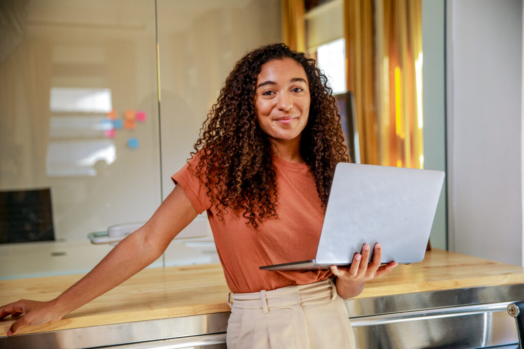A woman holding a laptop