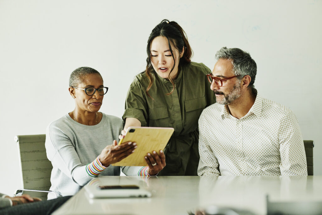 A group of people looking at a tablet