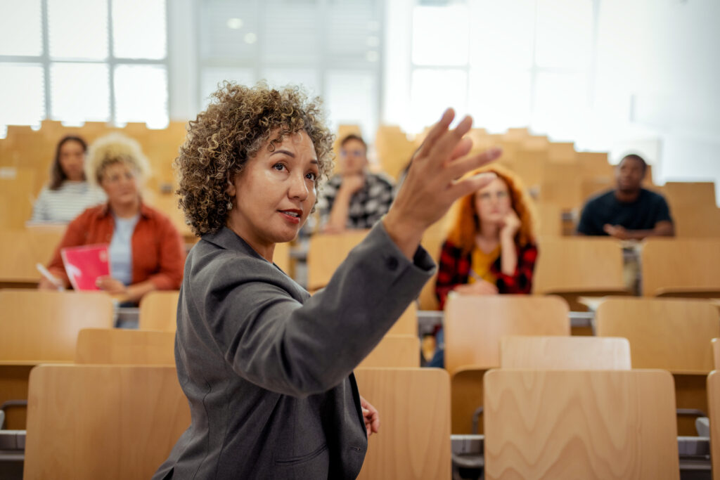 A woman raising her hand in a classroom