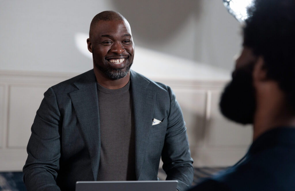 Two colleagues in an office environment with a laptop