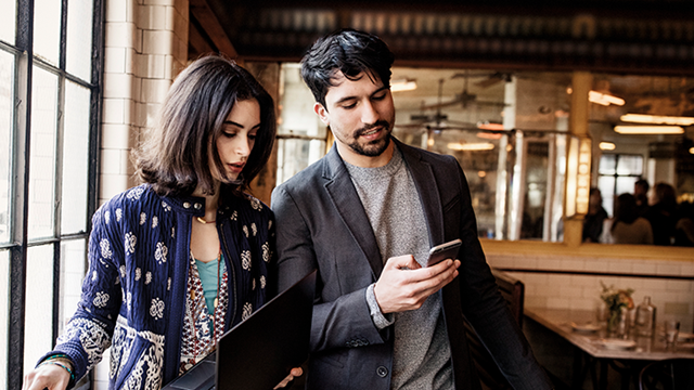 Featured image shows two people using devices in a restaurant, to show the mobility of the new Planner mobile app.