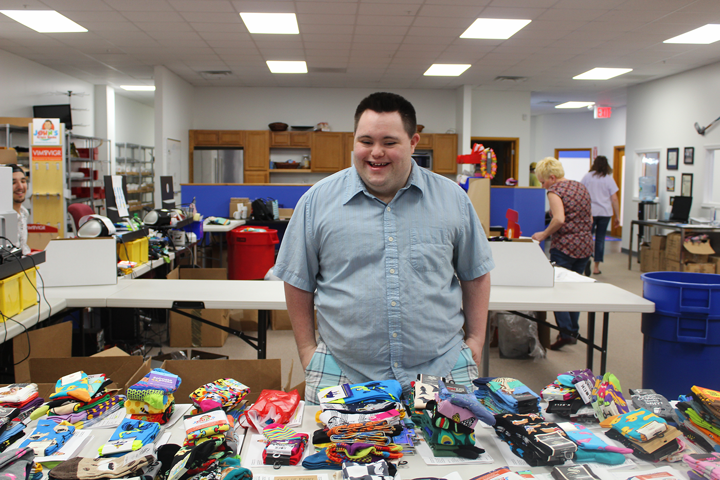 Image of a man perusing socks from John's Crazy Socks.