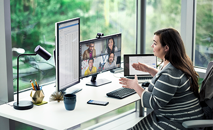Image showing a woman working at her desk, holding an online meeting.