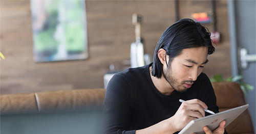 Image of a small business male with a Surface in modern workplace.