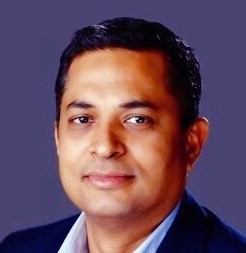Headshot of Srini Raghavan with purple background.