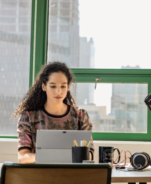 a person sitting in front of a laptop computer