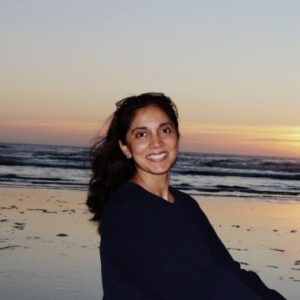 a person standing on a beach posing for the camera