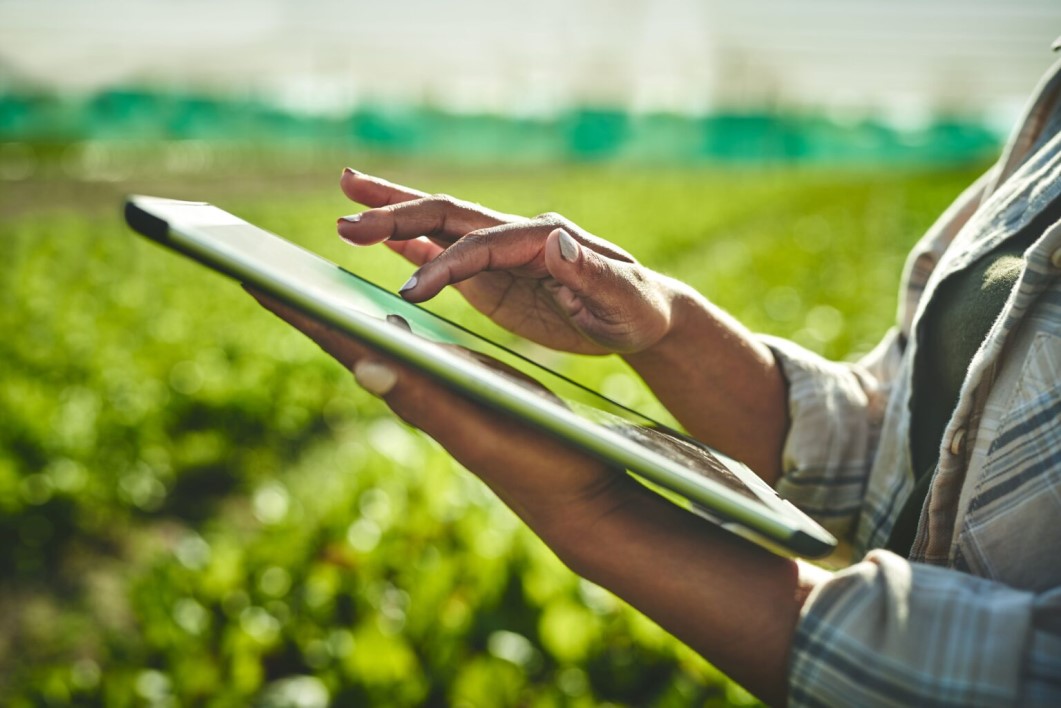 Shot of an unrecognisable woman using a digital tablet while working on a farm.