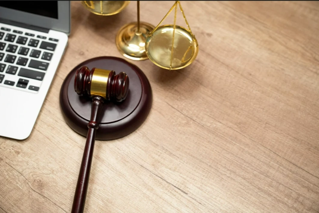 A gavel and scales on a desk AI-generated content may be incorrect.