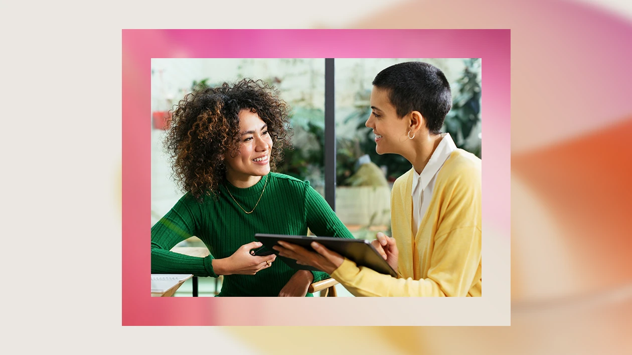 A woman holding a tablet and smiling