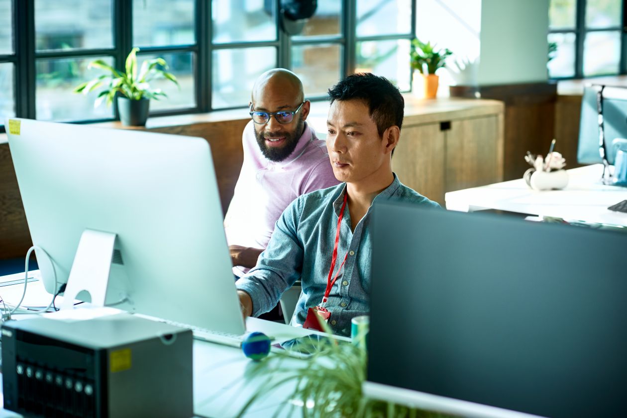 A group of men looking at a computer screen