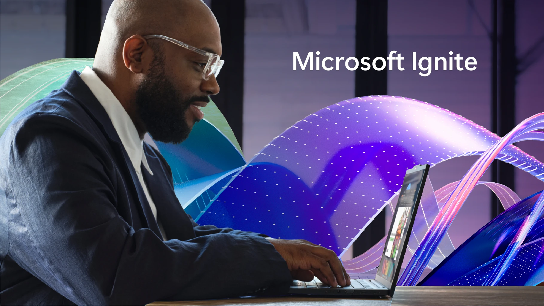 A Man working on his laptop. The image is titled Microsoft Ignite