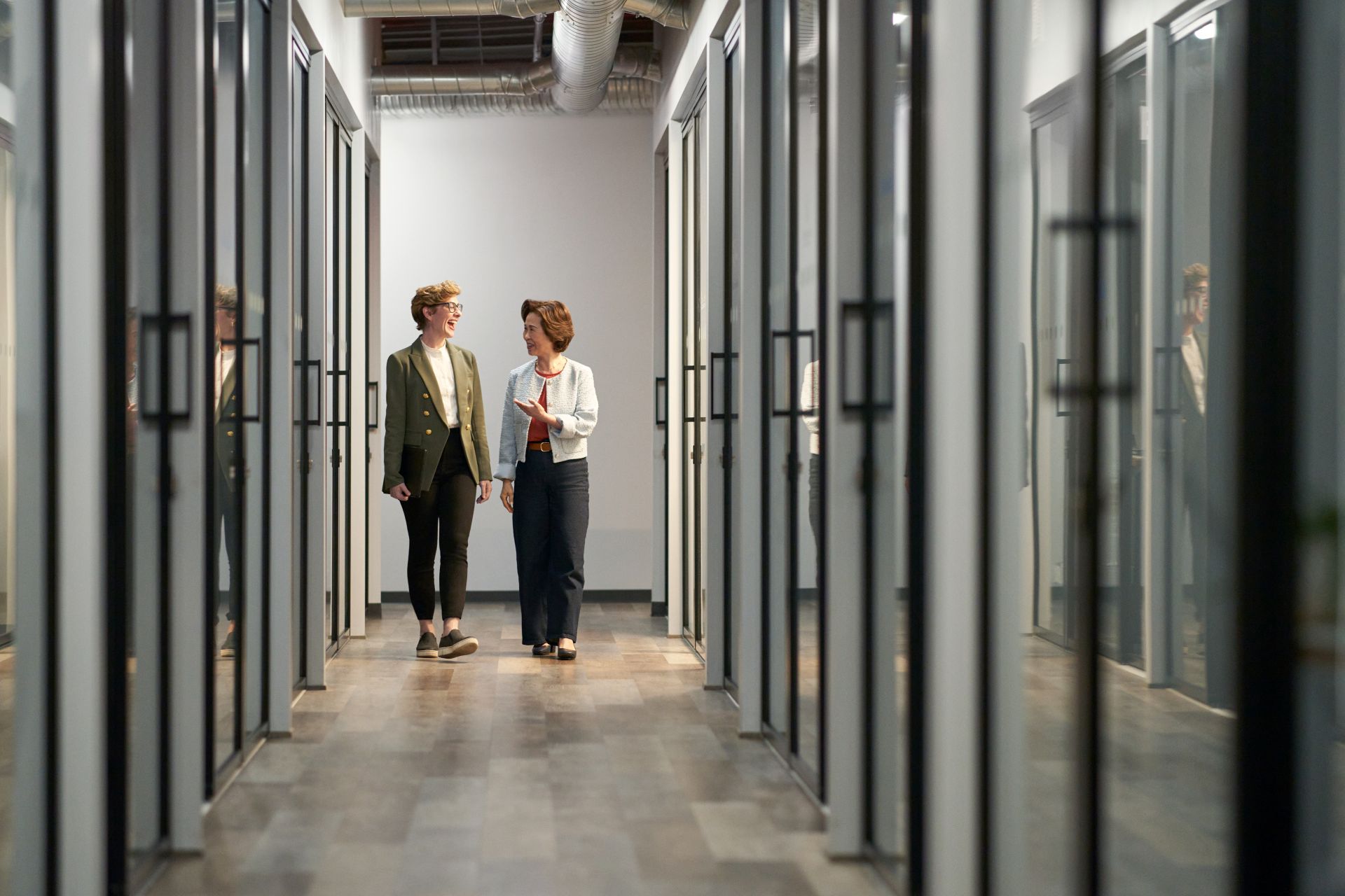 Two professionals collaborating in a modern, technology-enabled workplace.