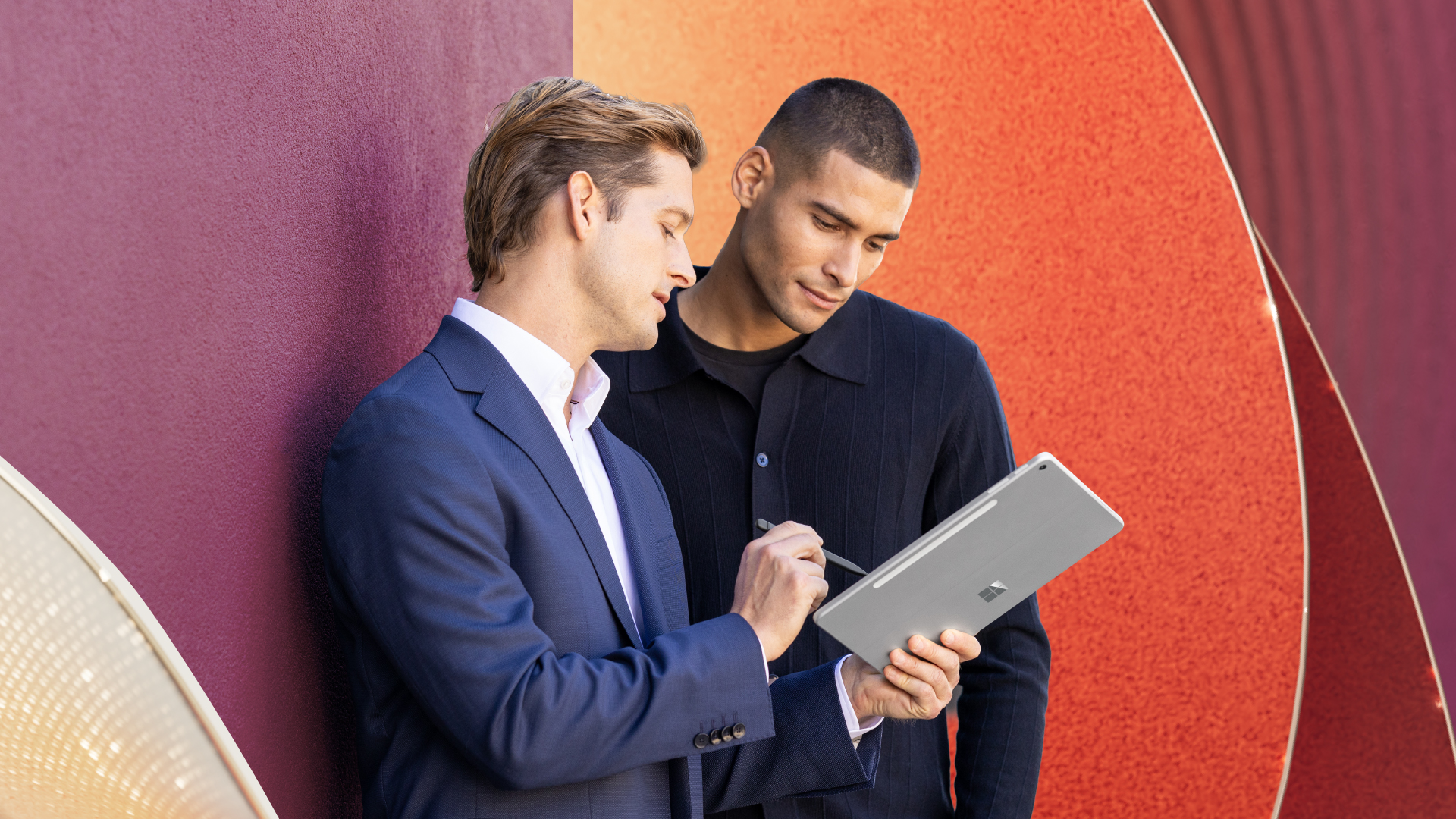 Financial professionals review information on a tablet.