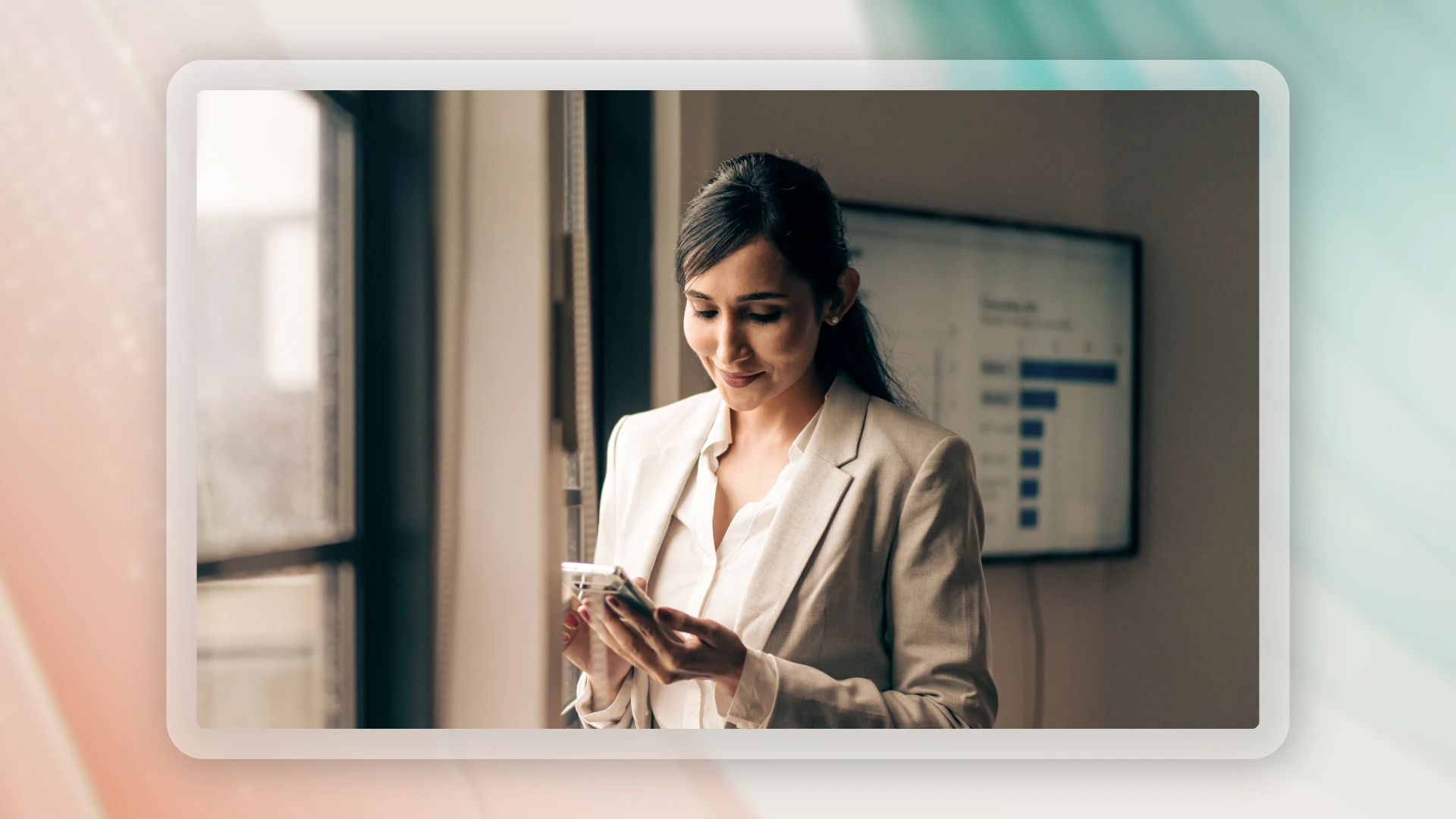 Professional woman looking at her phone in an office