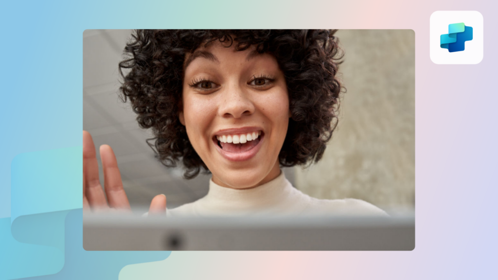 A woman waving at her laptop, greeting someone on a video call