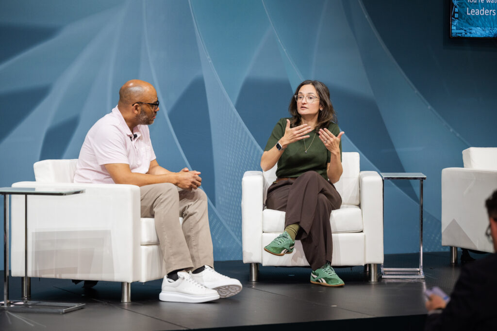 Two speakers having a conversation on stage.
