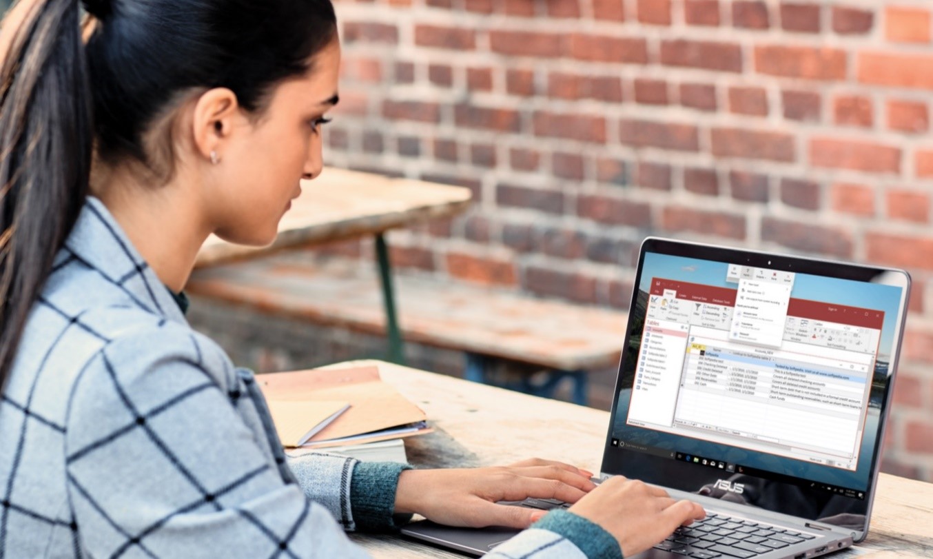 Woman sitting at laptop using Microsoft Power Automate.