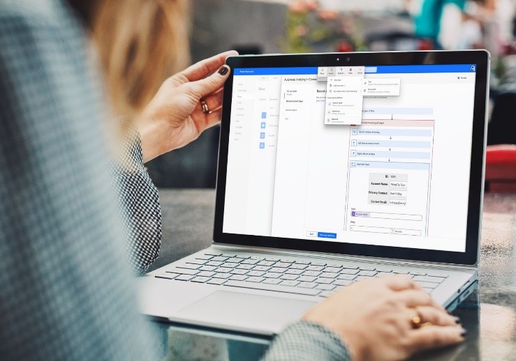 Person working on a laptop with Microsoft Power Automate.