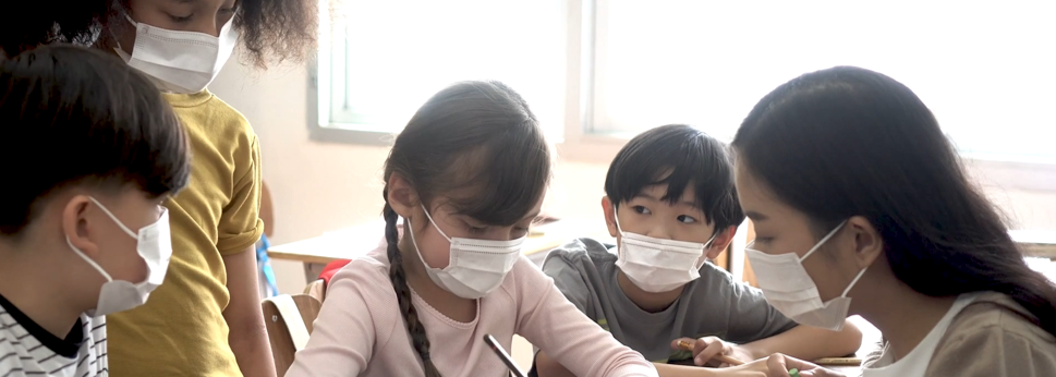 Students in masks working.