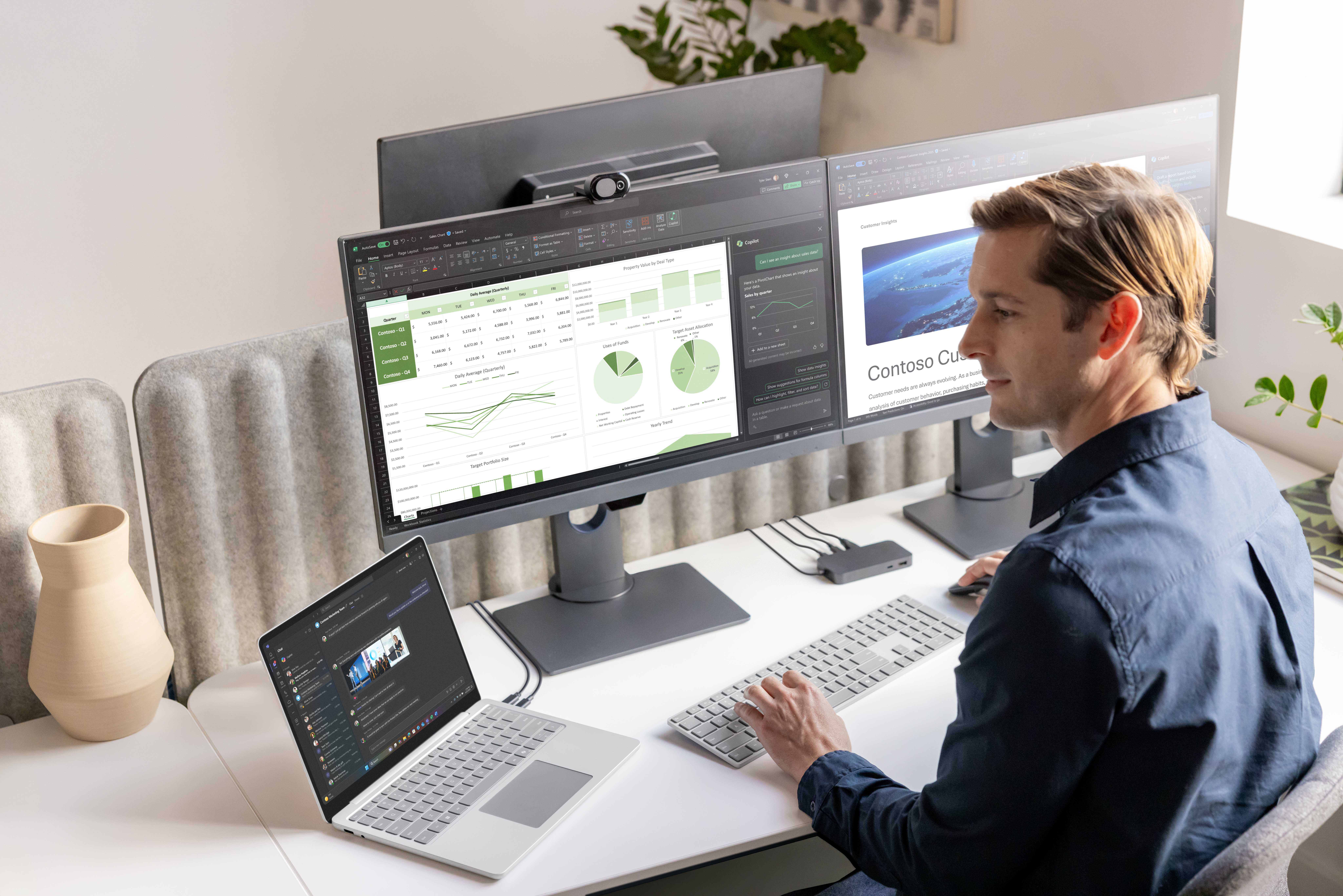 A man sitting at a desk with multiple computer screens