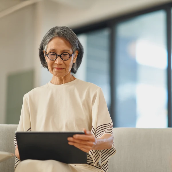 woman sitting with tablet device