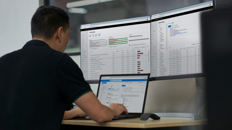A man sitting at a desk with a laptop