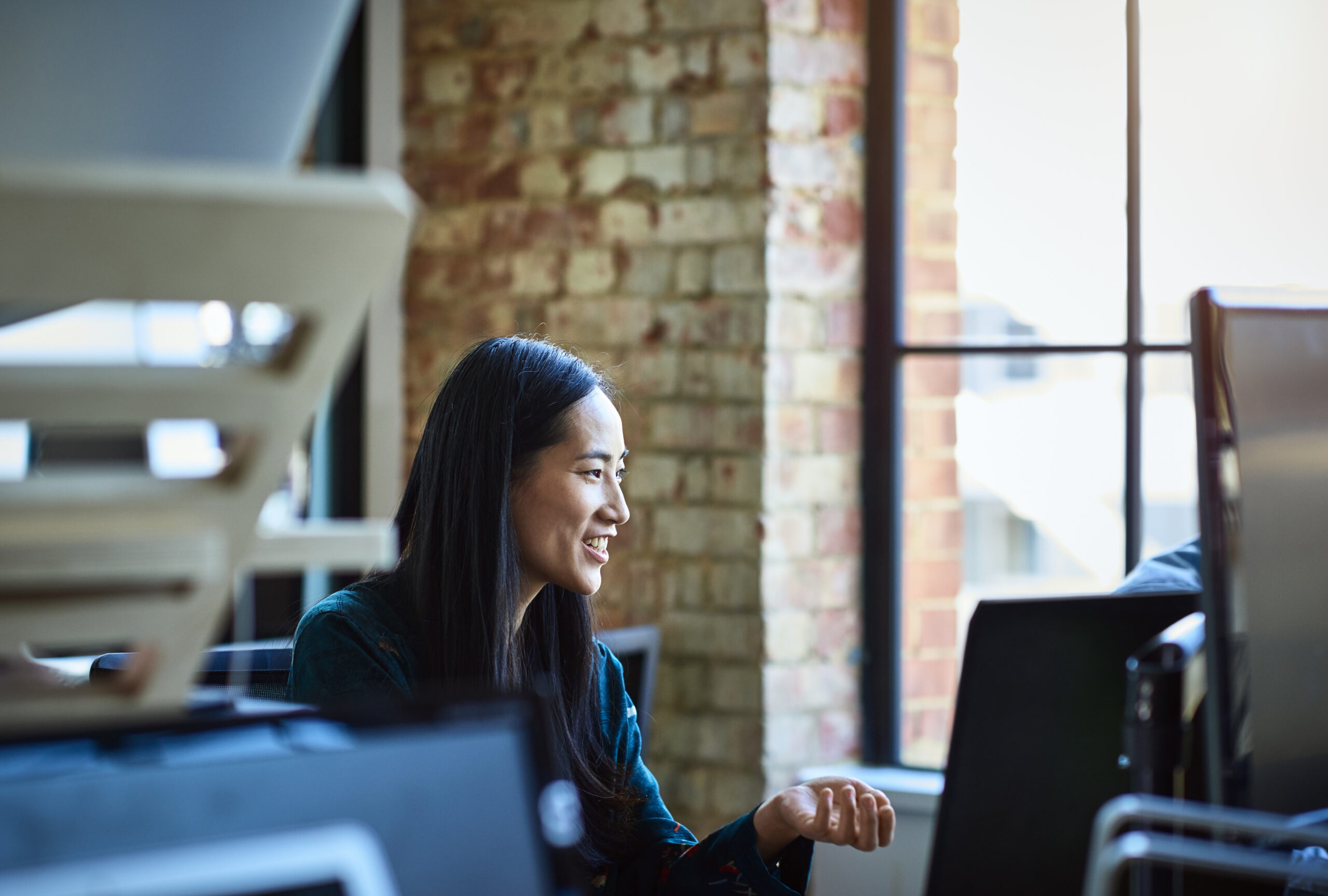 A woman smiling at a computer