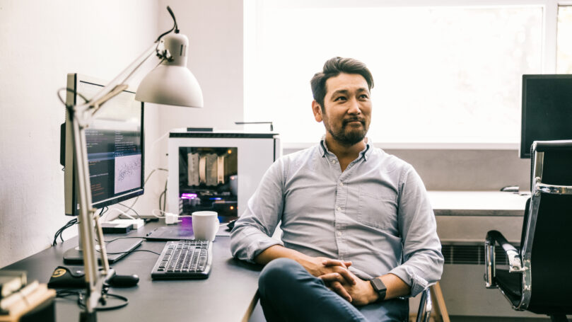 A man sitting at a desk with a computer