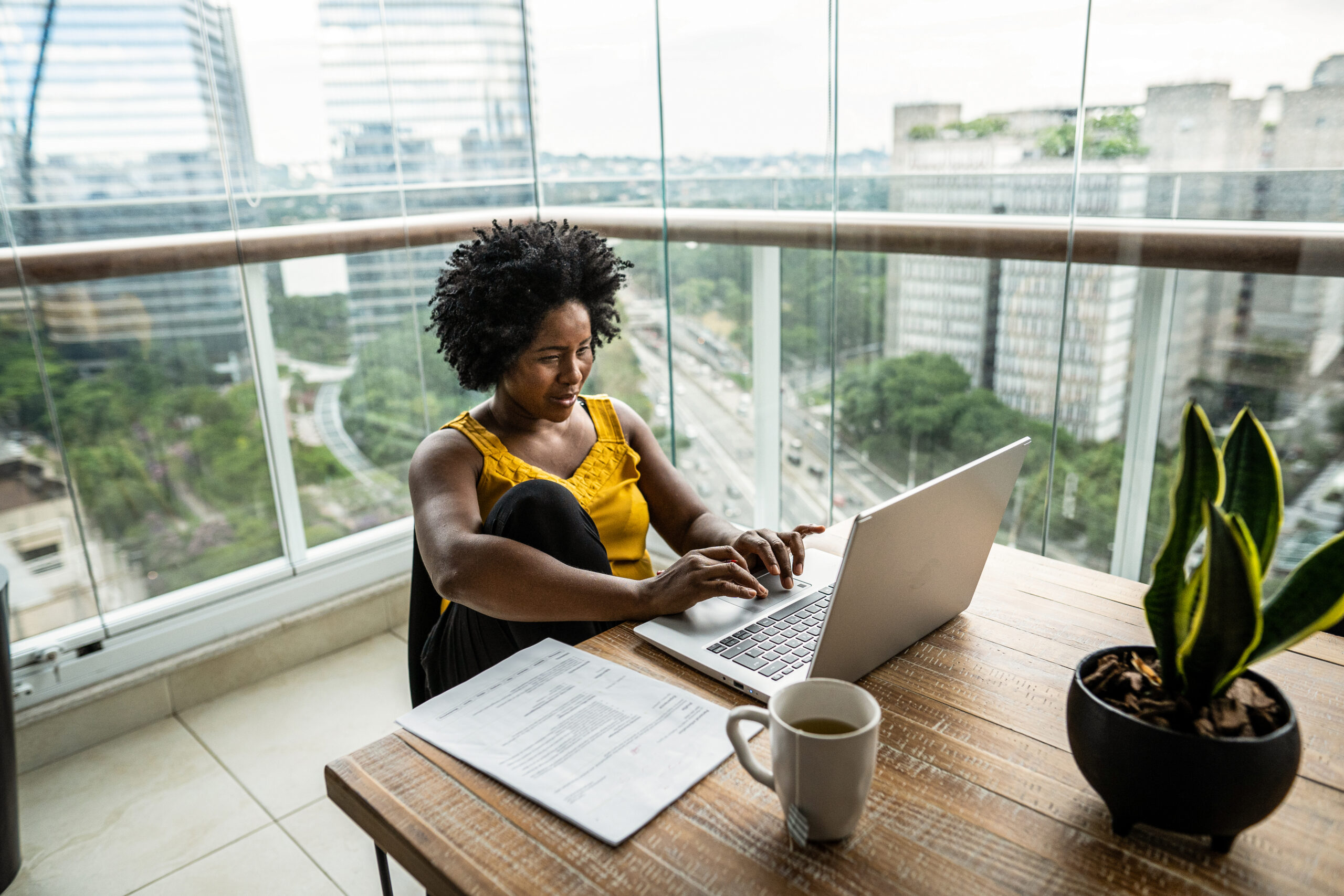 A woman sitting at a table with a laptop