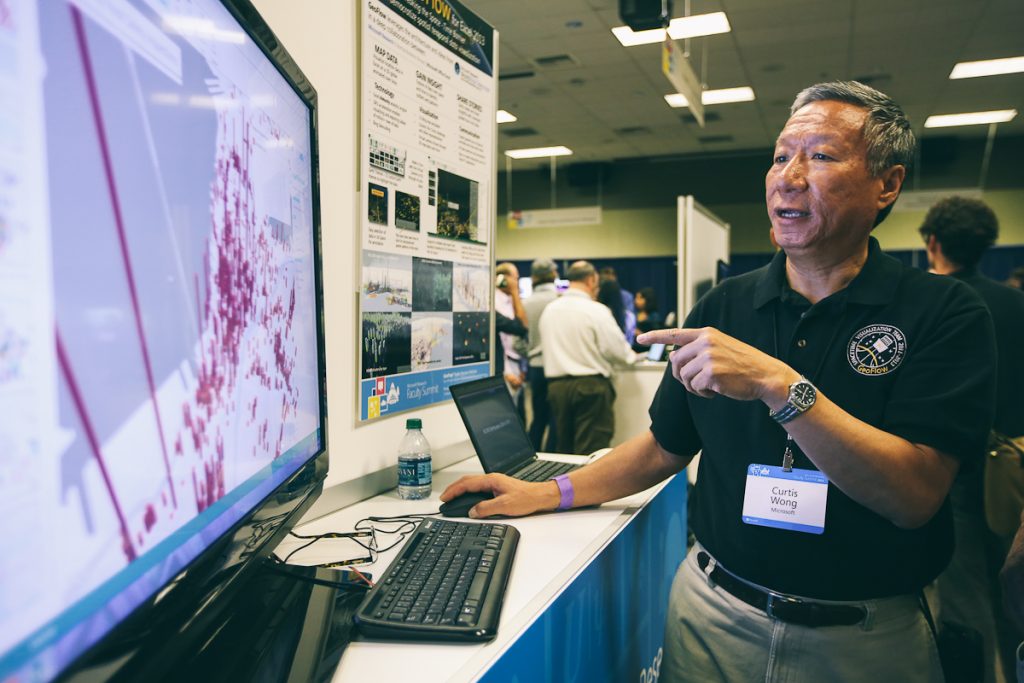 a man standing in front of a laptop computer