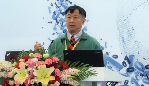 a man standing in front of a flower