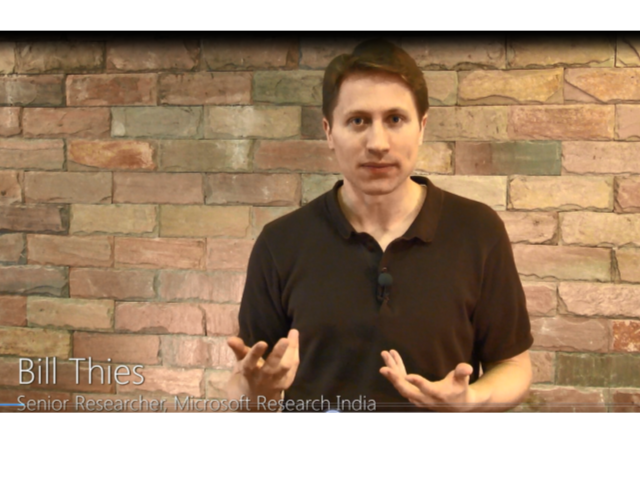 a person standing in front of a brick wall