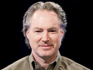 Eric Horvitz wearing a suit and tie smiling at the camera