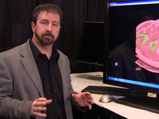 a man standing in front of a computer
