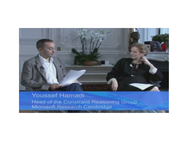 a man sitting in front of a flat screen television