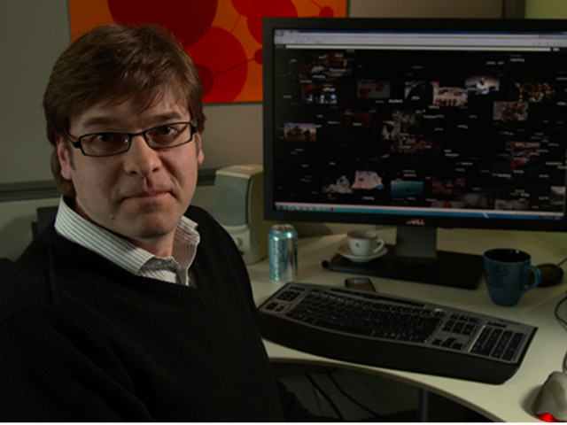 a man sitting at a desk in front of a computer
