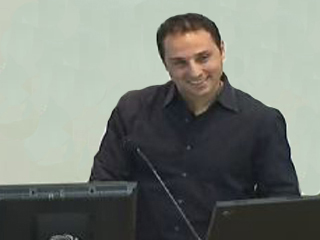 a man sitting in front of a laptop computer