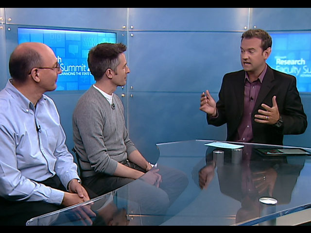 a group of people looking at a screen